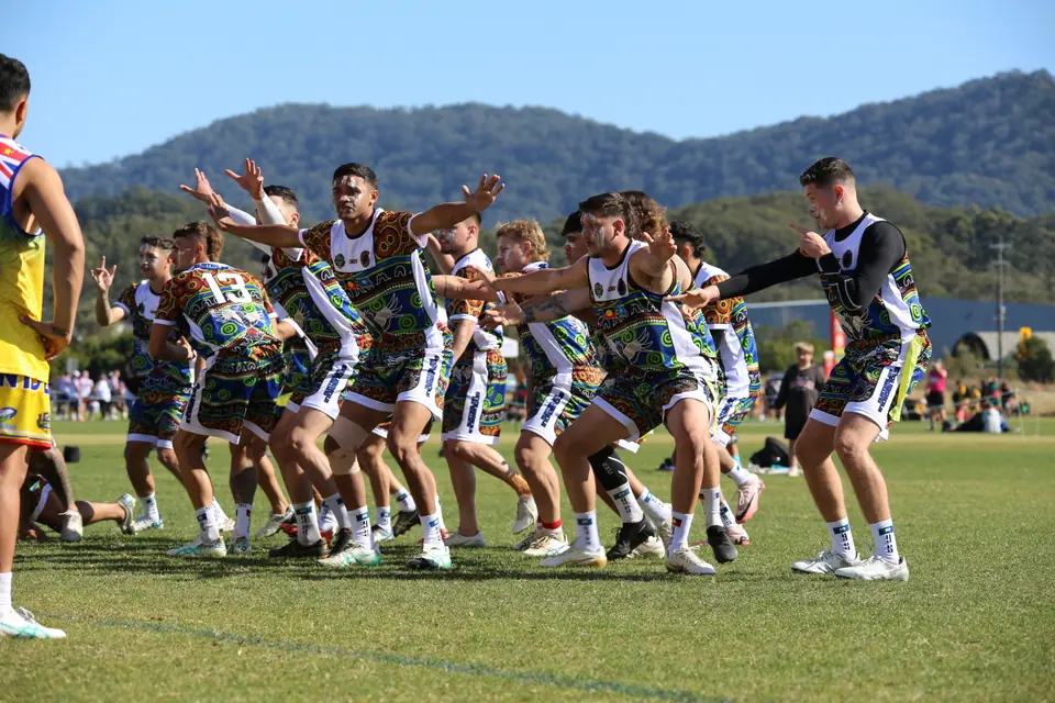 An AIO side performs a cultural dance on the field at the 2024 Australian Invitational Challenge